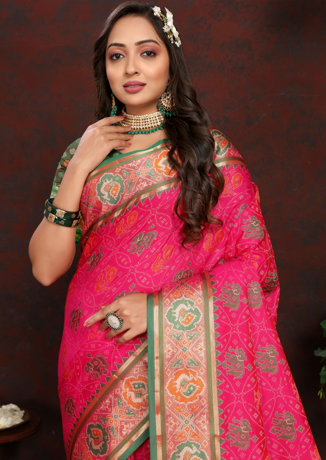 Pink & Green Women's Soft Patola Silk meenakari weawing motifs with Rich Zari Pallu and contrast border with Tessels.